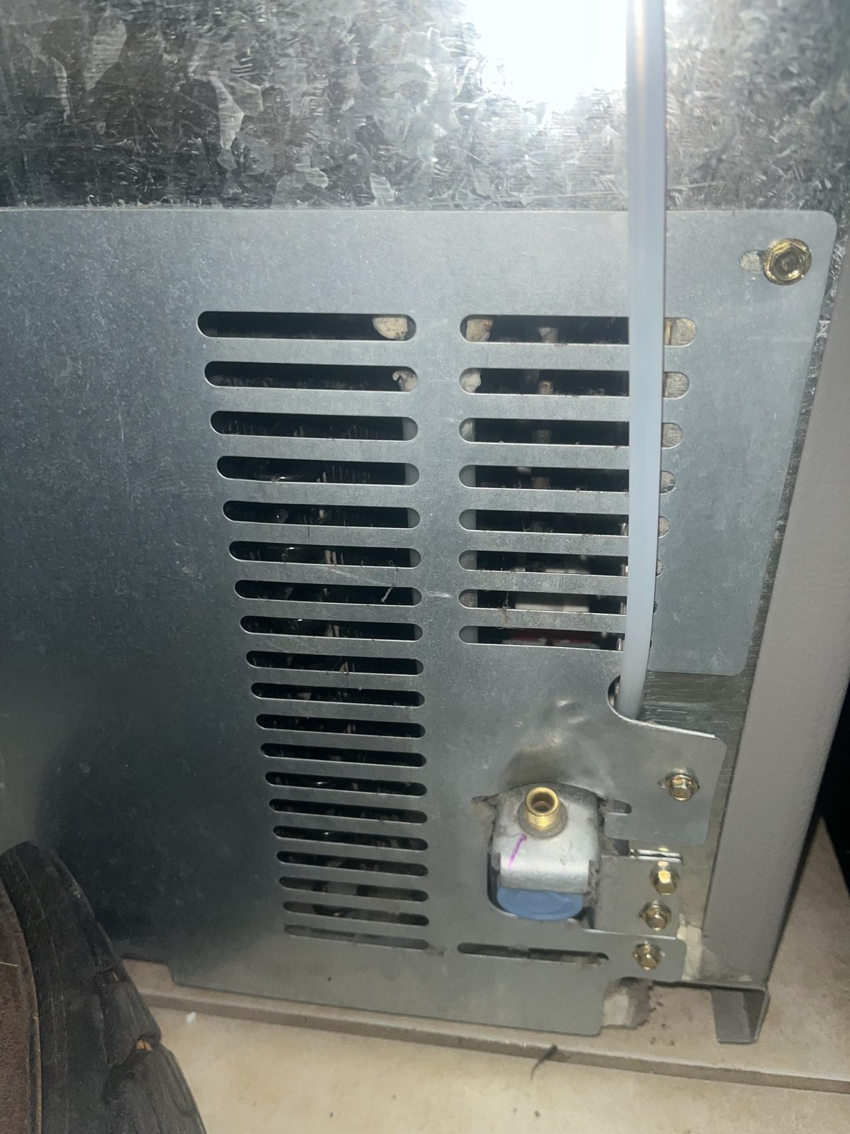 Lower appliance panel and surrounding floor area documented during sample visit