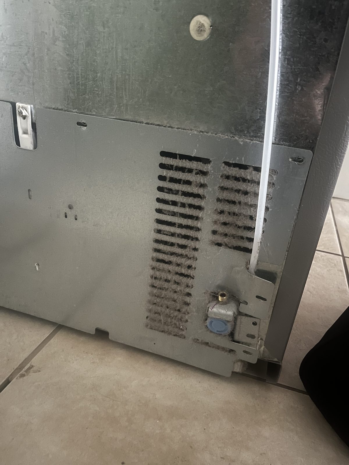 Rear lower refrigerator access panel documented during sample visit